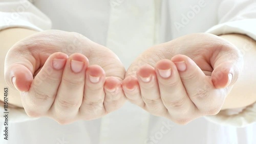 Putting her hands together and showing them towards camera : creative concept