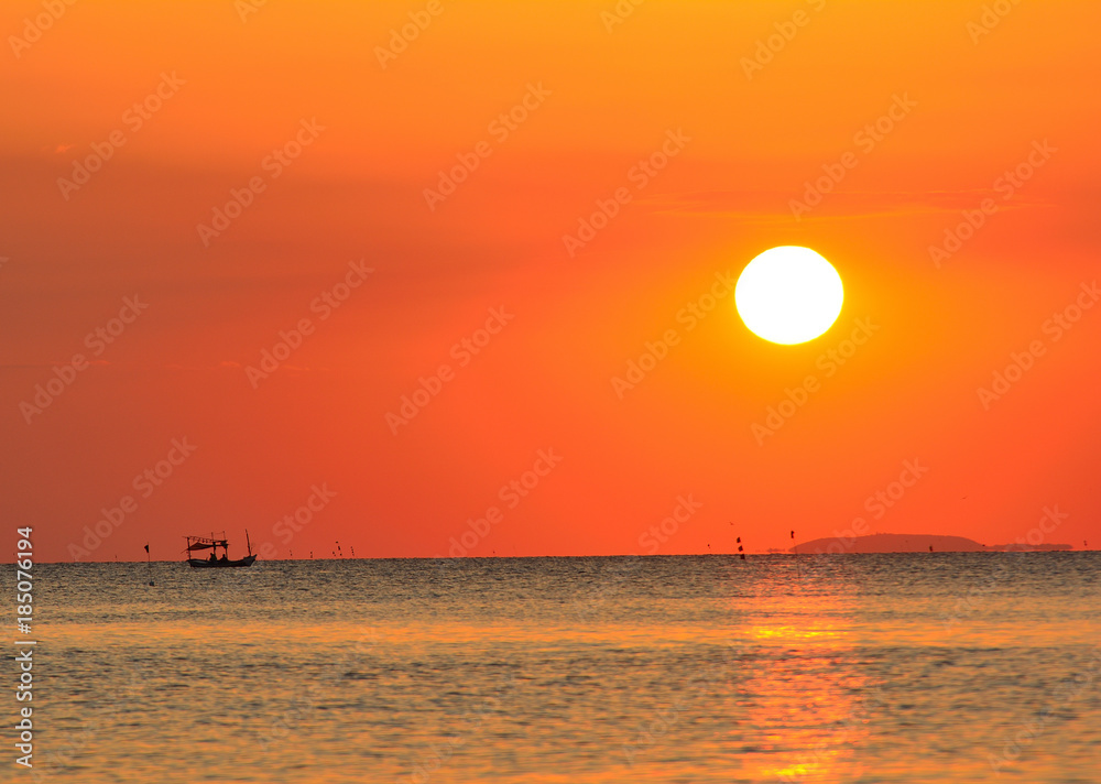 Fishing boat in the sea Having a sunset is the background