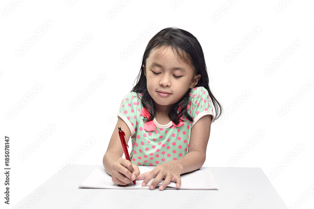 Portrait of asian little girl with pen writing in the book Portrait of asian little girl with pen writing in the book
