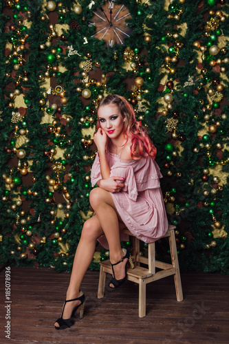 Portrait of the Beautiful woman posing on Christmas background.