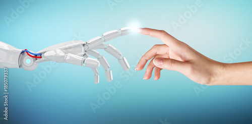 Human hand touching an android hand.