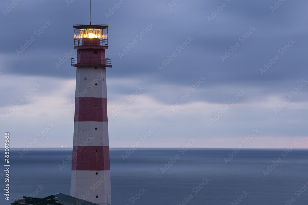 Lighthouse searchlight beam through marine air Lighthouse searchlight beam through marine air