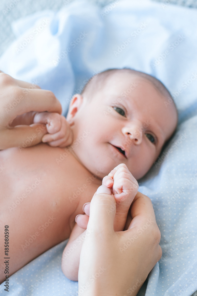 cute newborn baby hold mother by the thumbs. happy motherhood. family values. cute newborn baby hold mother by the thumbs. happy motherhood. family values.