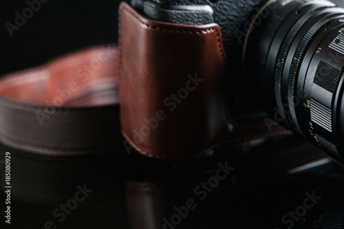 mirrorless camera on black background. professional photography courses. lifestyle of creative people