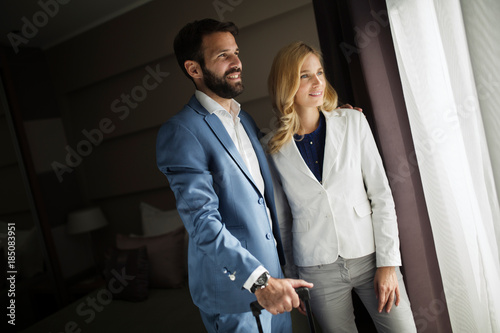 Picture of businessman and businesswoman in hotel room