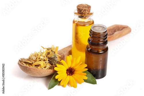 Fototapeta Naklejka Na Ścianę i Meble -  aromatherapy essential oil with marigold flowers isolated white background
