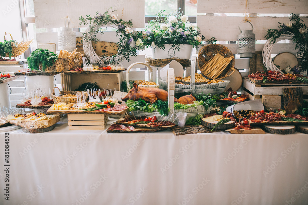Meat, cheese and nutmeg wedding buffet with various snacks.