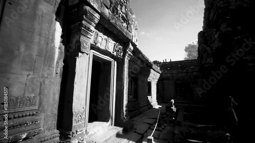 Whip pan transition movement across the interior of Banteay Srei temple with lens flares showing the ancient hindu temple structure. photo