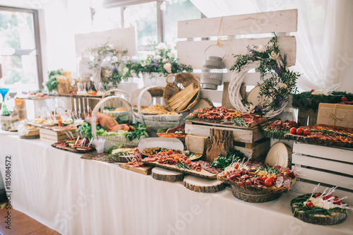 Meat, cheese and nutmeg wedding buffet with various snacks.