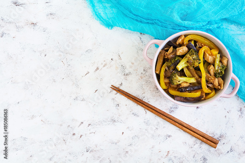 Stir fry chicken, broccoli and pepper on white background