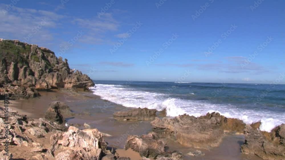 A full shot of a seashore and waves with sky A full shot of a seashore and waves with sky