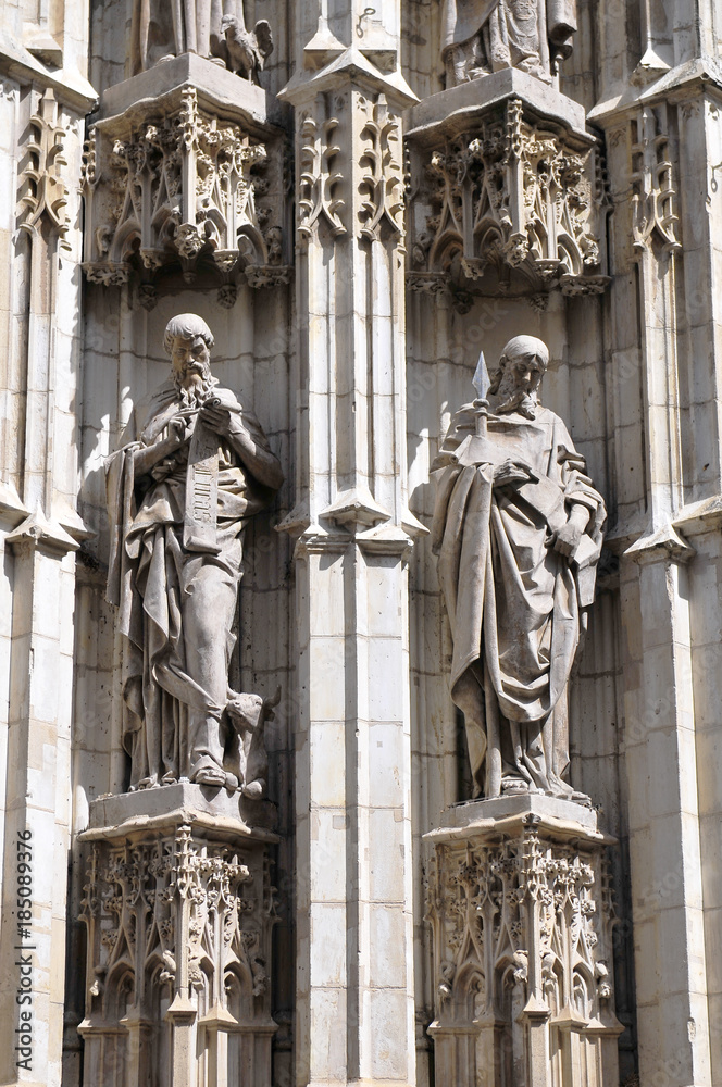 Fototapeta premium Statues of saints carved in stone, detail of exterior in the Cathedral of Seville, Andalusia, Spain. 