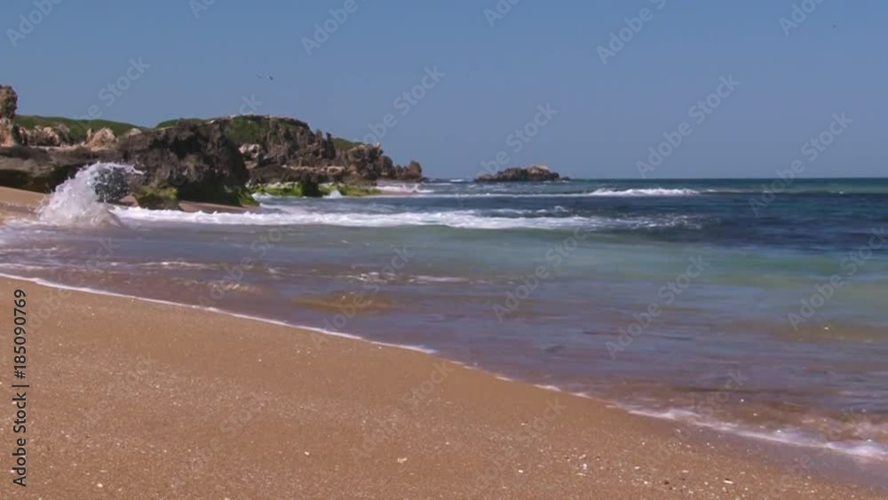 A full shot of a seashore and waves with sky A full shot of a seashore and waves with sky