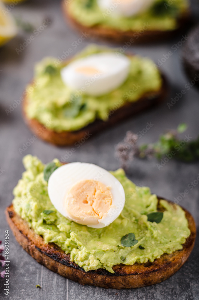 Bio avocado on bread with boiled egg