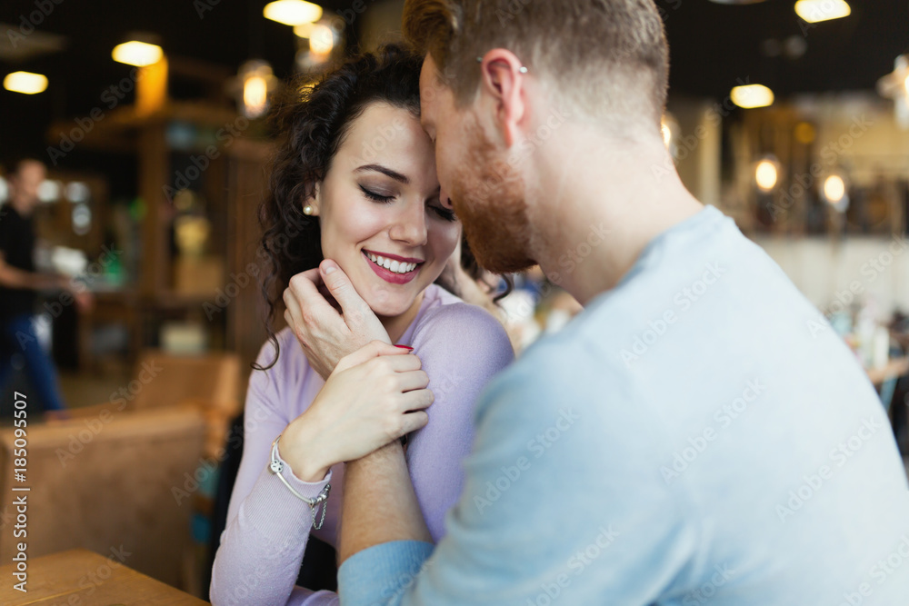 Fototapeta premium Young happy couple on date in coffee shop