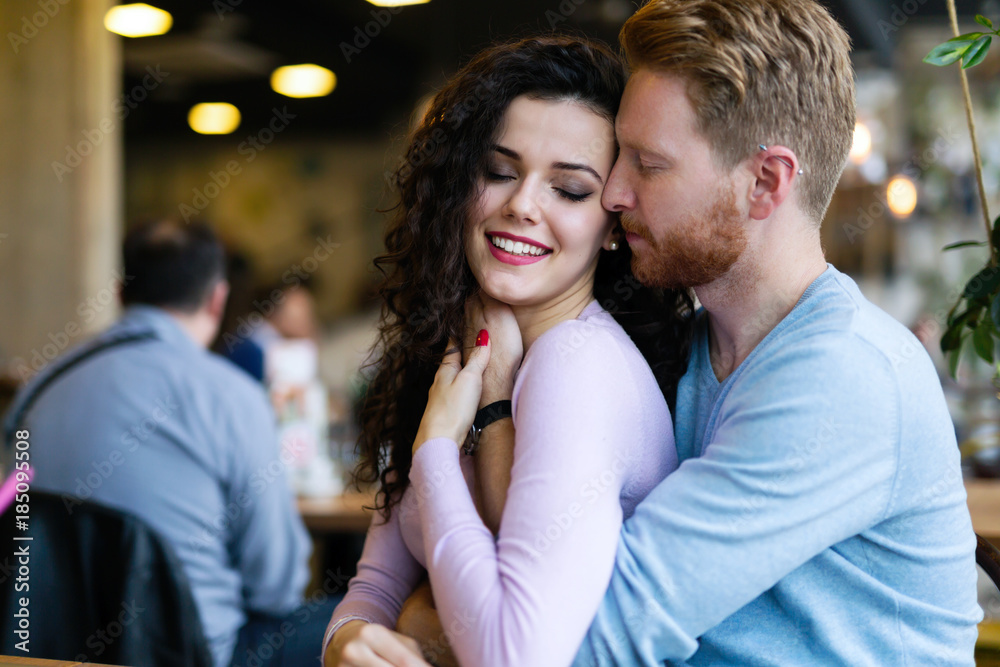 Fototapeta premium Young happy couple on date in coffee shop
