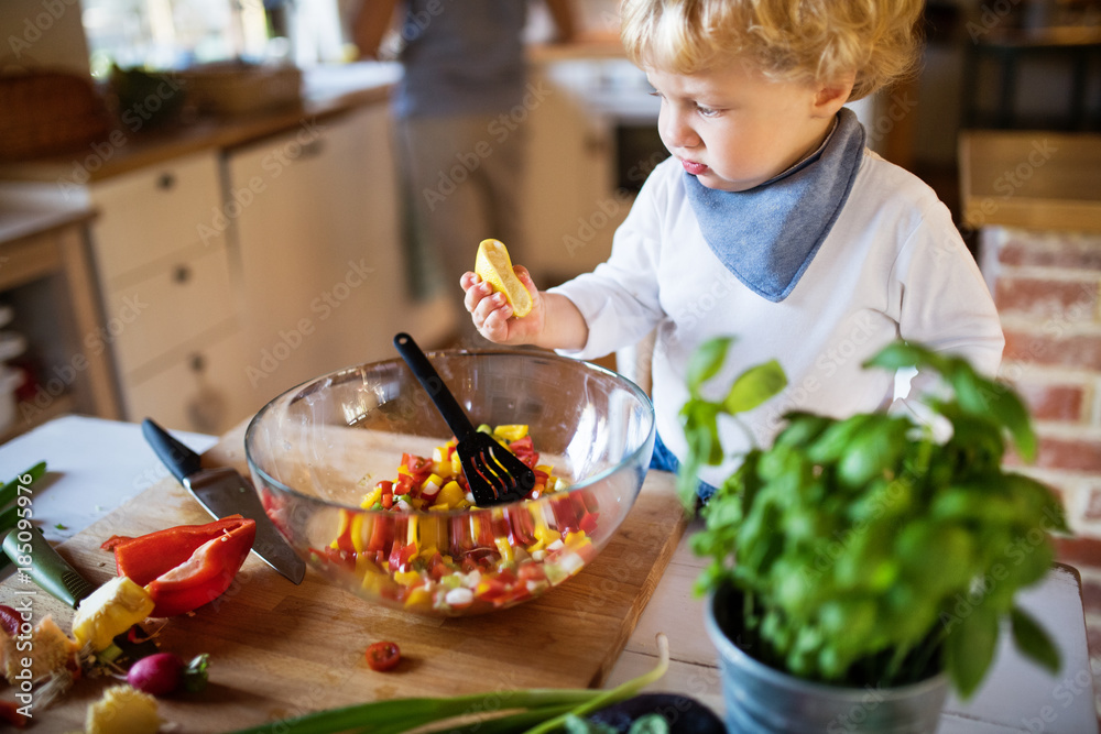 Young father with a toddler boy cooking. Young father with a toddler boy cooking.