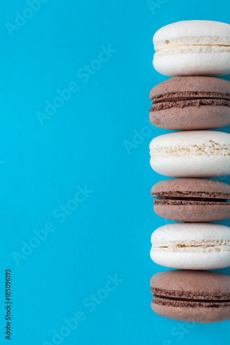 Vanilla and coffee macaroons on a blue background