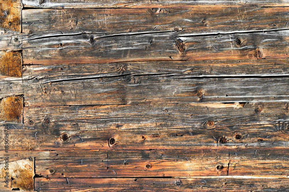 Naklejka premium Old natural brown wood wall of log cabin. Wooden textured background pattern.