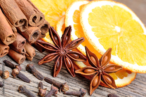 Cinnamon with orange fruit anise and cloves on table