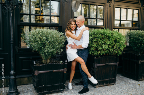 Young couple in white clothing near the plants 