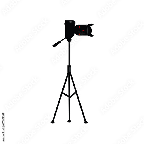 vector flat cartoon lens photo camera standing at special tripod stand side view. Professional photo equipment. Isolated illustration on a white background.