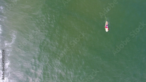 Aerial top view of surfing man in Hainan, China