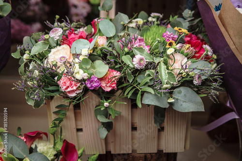 flowers in wooden box with cloves, alstromeria, and greens