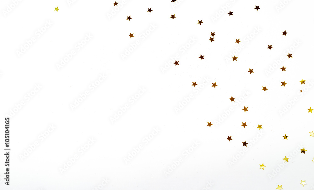Fototapeta premium Christmas composition. a pattern of golden christmas stars from above. Flat lay, top view