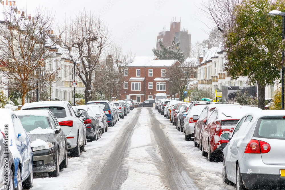 Terraced street covered with snow around West Hampstead area in London