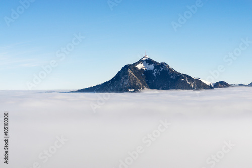 Mountain stick out of foggy cloud layer. Gruenten, Bavaria, Germany. Foresight and vision for business concept and ideas. © Drepicter