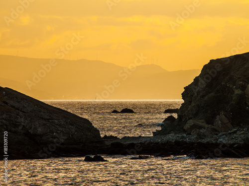 rocky coastline  strait of Gibraltar  Spain  Europe view from a cliff to the sea the mountains in the background are morocco