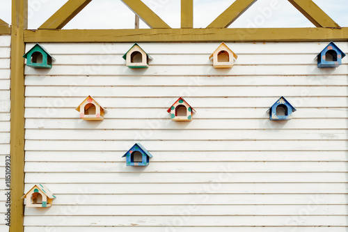 decorative nesting boxes on a wooden wall