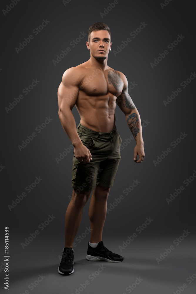 Fitness male model shirtless full-length portrait