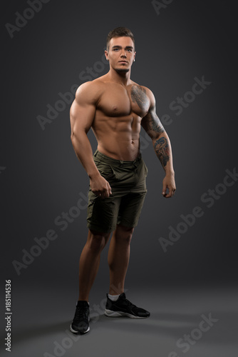 Fitness male model shirtless full-length portrait