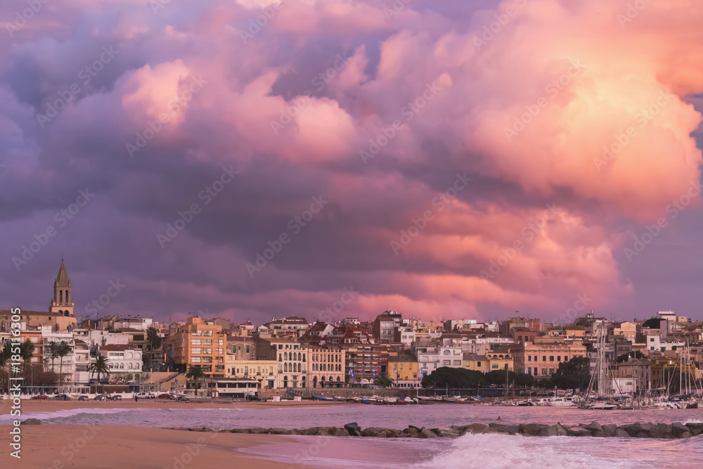 Beautiful sunset in Spain with big clouds, Costa Brava, town Palamos