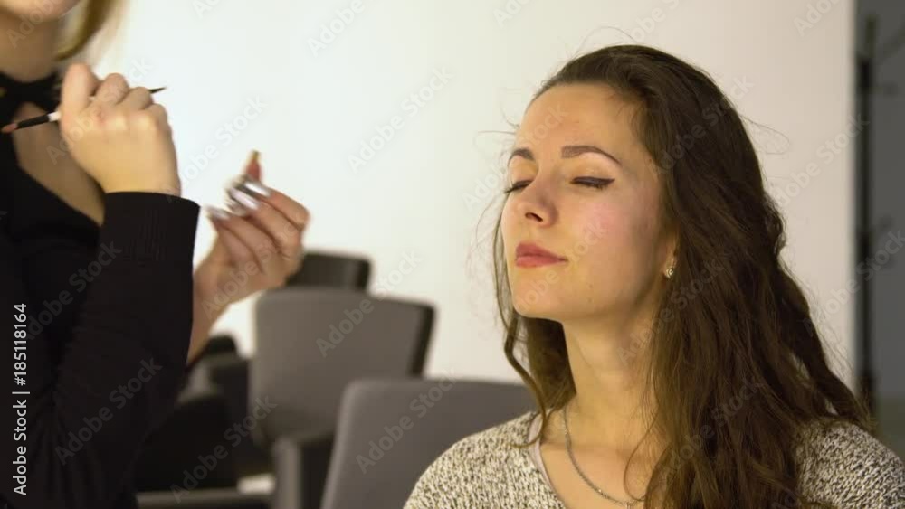 Young beautiful girl in beauty salon. Make-up artist does make-up. 4K. Young beautiful girl in beauty salon. Make-up artist does make-up. 4K.