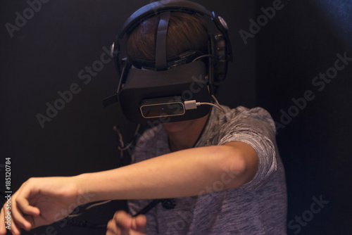 Teenager boy playing with 3d glasses in virtual reality videogame