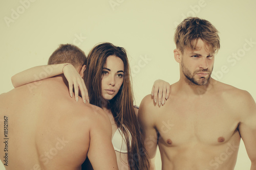 Girl with long hair in sexy bra hug machos