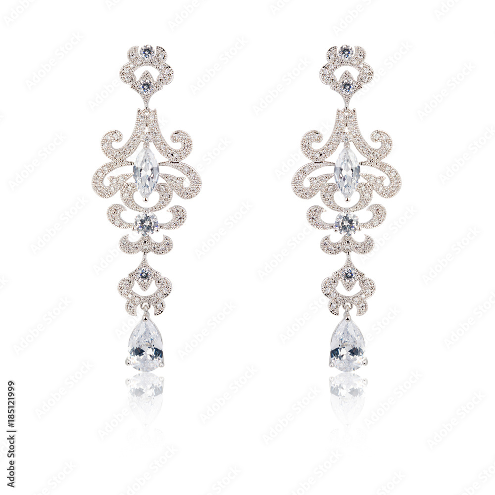 Pair of silver diamond earrings isolated on white Pair of silver diamond earrings isolated on white