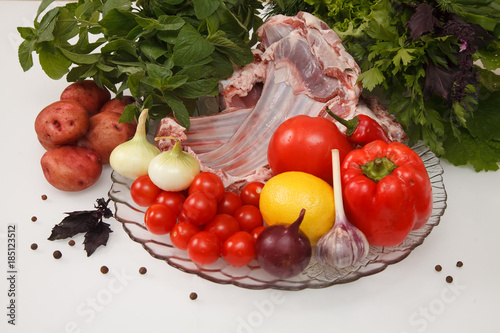 Raw lamb meat with vegetables photo