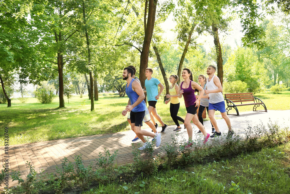 Fototapeta premium Group of young people running in park
