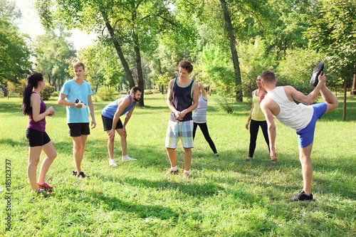 Group of young people resting after training in park