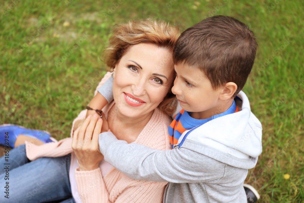 Happy senior woman with grandson in park Happy senior woman with grandson in park