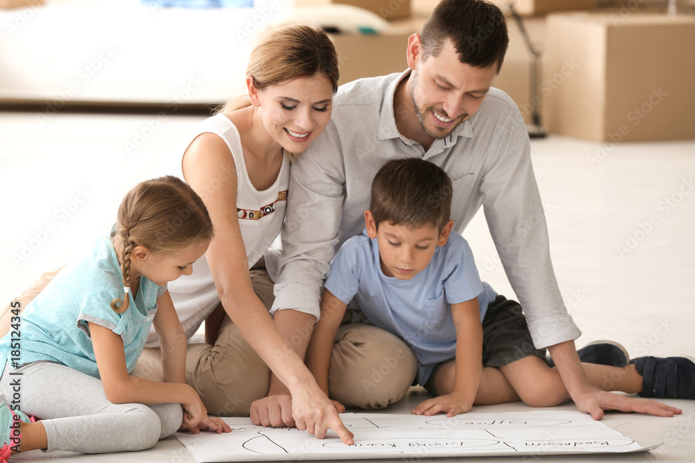 Happy family studying project of new flat Happy family studying project of new flat