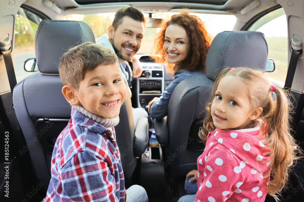 Cute children with parents in car