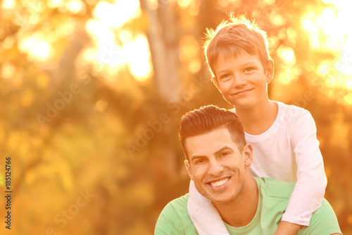 Father and his son outdoors on sunny day