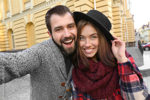 Young adorable couple takin...