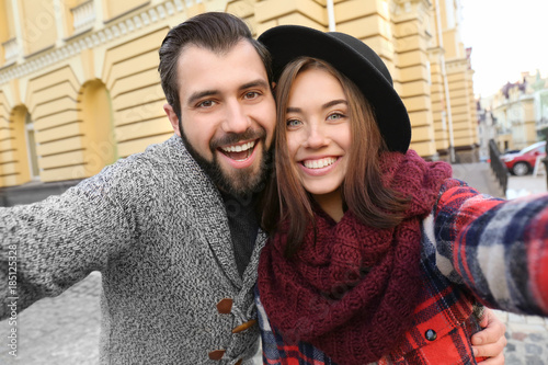 Young adorable couple takin...