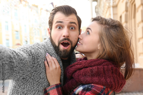 Young adorable couple takin...